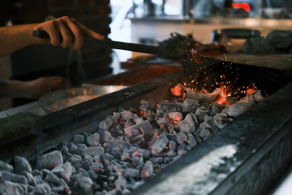 Close-up of glowing coals on a grill being prepared for a barbecue in Diyarbakır, Turkey.
